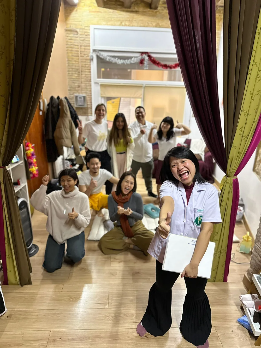 An instructor with her class at the end of a course
