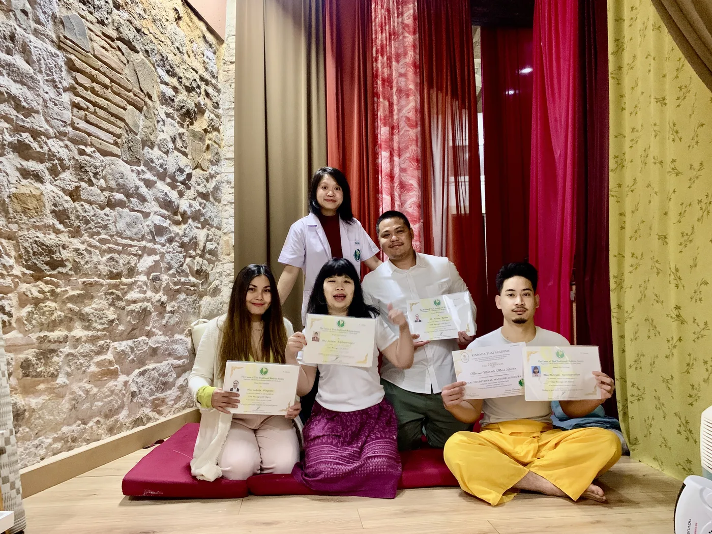 Students holding their certificates after completing a course
